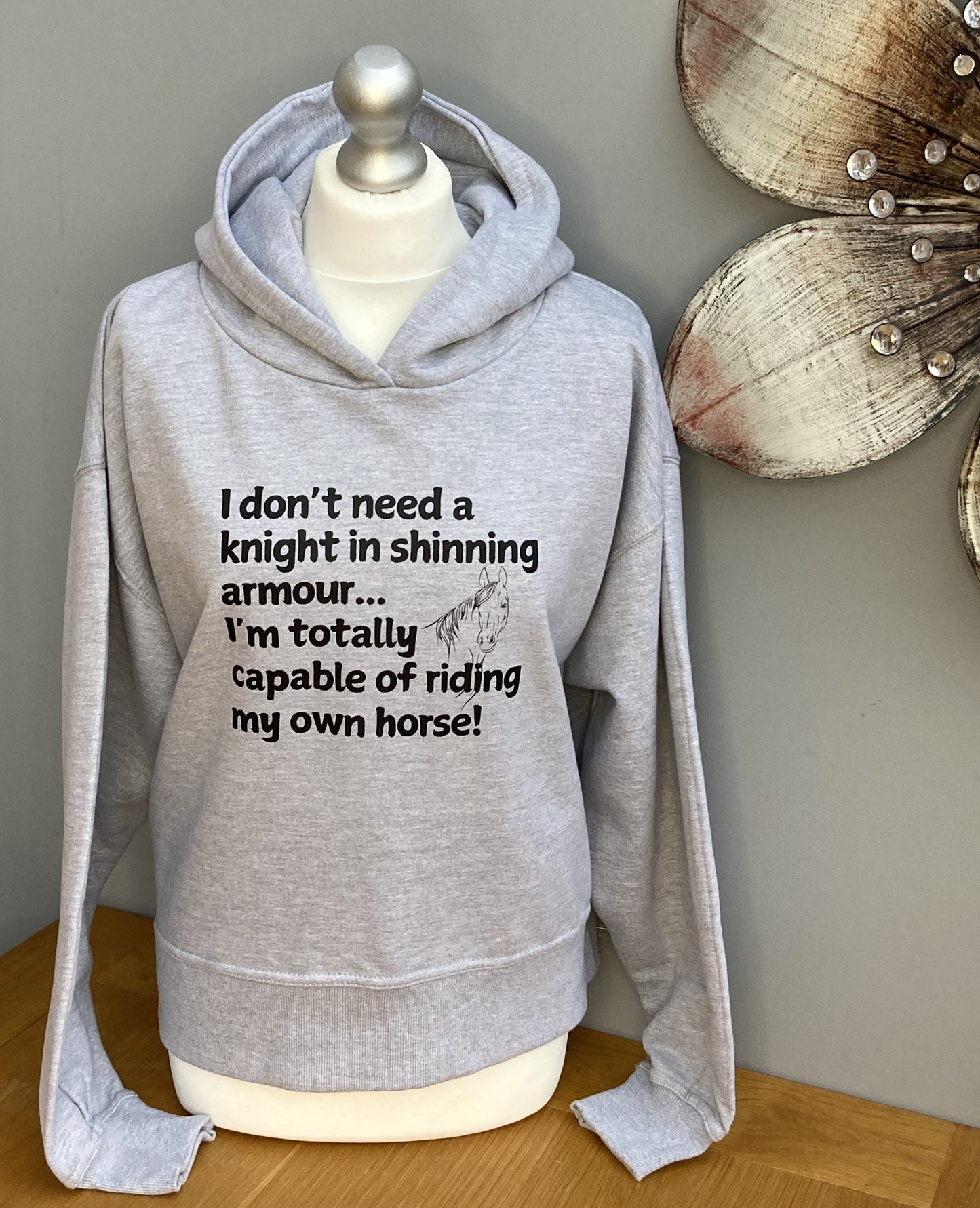 grey cropped hoodie printed on the front with wording, I don't need a knight in shinning armour...im totally capable of riding my own horse!